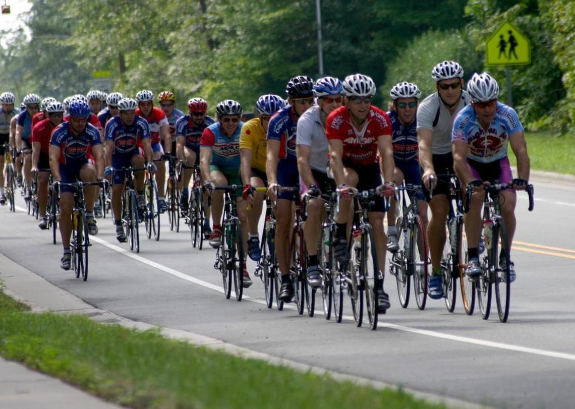 A pack of cyclists fill the road in Carrboro on Saturday morning in this 2005 file photo. Cycling has become a big business in the United States and in North Carolina, where 35 bike equipment manufacturers and 229 bike retailers do business. Congressman David Price visited Performance Bicycle in Chapel Hill this week to talk about that economic impact and express his support for continued federal funding for bike infrastructure projects.