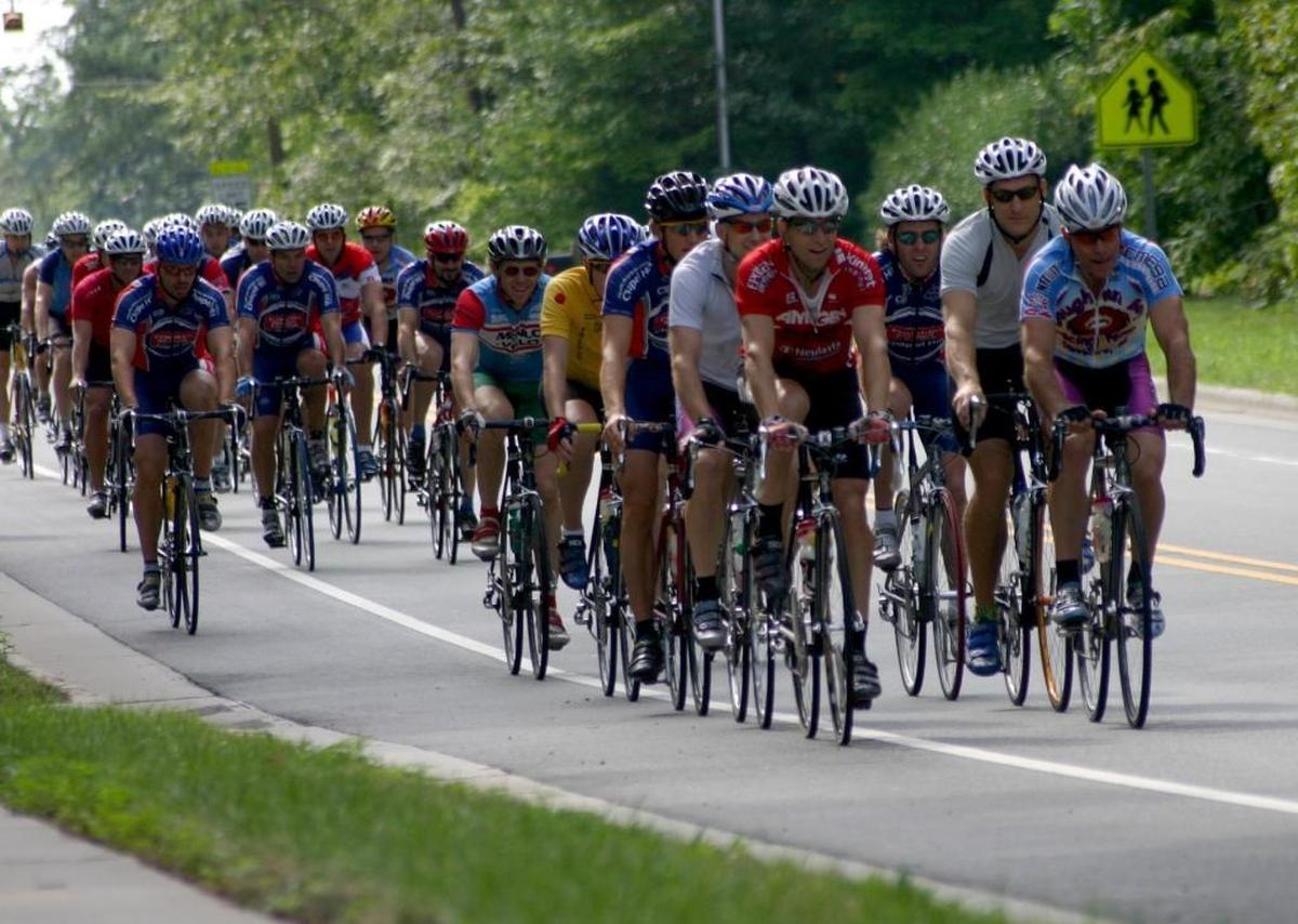 A pack of cyclists fill the road in Carrboro on Saturday morning in this 2005 file photo. Cycling has become a big business in the United States and in North Carolina, where 35 bike equipment manufacturers and 229 bike retailers do business. Congressman David Price visited Performance Bicycle in Chapel Hill this week to talk about that economic impact and express his support for continued federal funding for bike infrastructure projects.