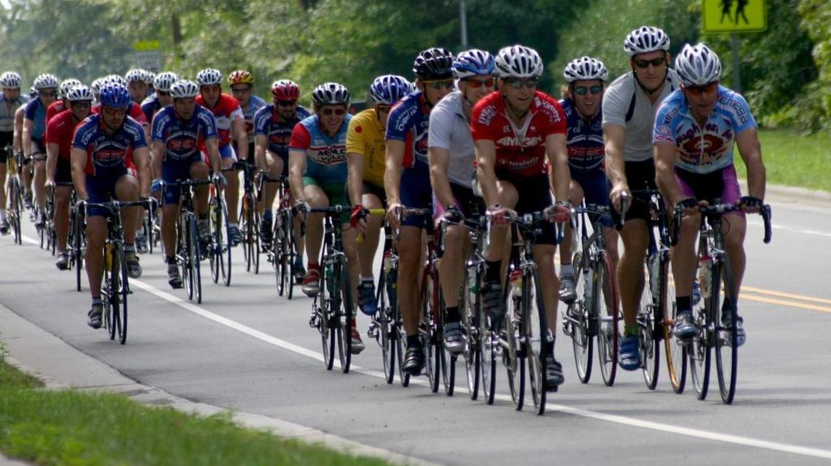A pack of cyclists fill the road in Carrboro on Saturday morning in this 2005 file photo. Cycling has become a big business in the United States and in North Carolina, where 35 bike equipment manufacturers and 229 bike retailers do business. Congressman David Price visited Performance Bicycle in Chapel Hill this week to talk about that economic impact and express his support for continued federal funding for bike infrastructure projects.