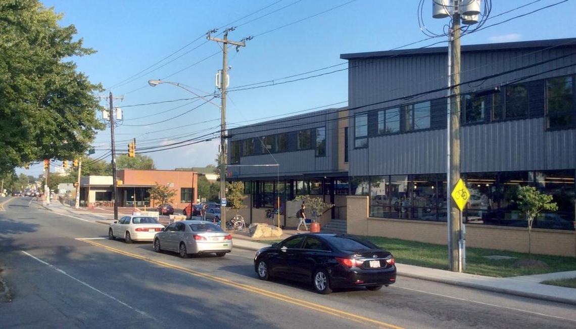 PTA Thrift Shop’s roughly $5.5 million capital project including a renovated Carrboro thrift store (right) at 125 W. Main St., an expanded parking lot, and a new YouthWorx on Main building (background, left) for nonprofits working with Chapel Hill and Carrboro young people.