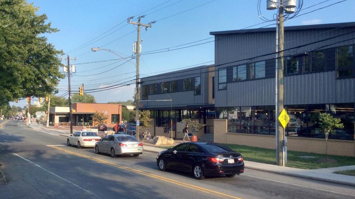 PTA Thrift Shop’s roughly $5.5 million capital project including a renovated Carrboro thrift store (right) at 125 W. Main St., an expanded parking lot, and a new YouthWorx on Main building (background, left) for nonprofits working with Chapel Hill and Carrboro young people.