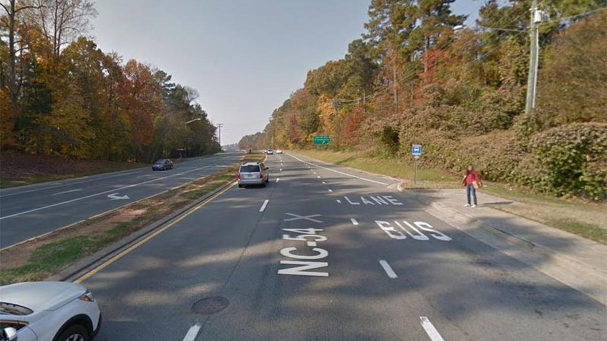 A passenger waits for a bus on the side of the road at this bus stop in Chapel Hill which is in the running for StreetBlog.org’s title of “America’s Sorriest Bus Stop.”