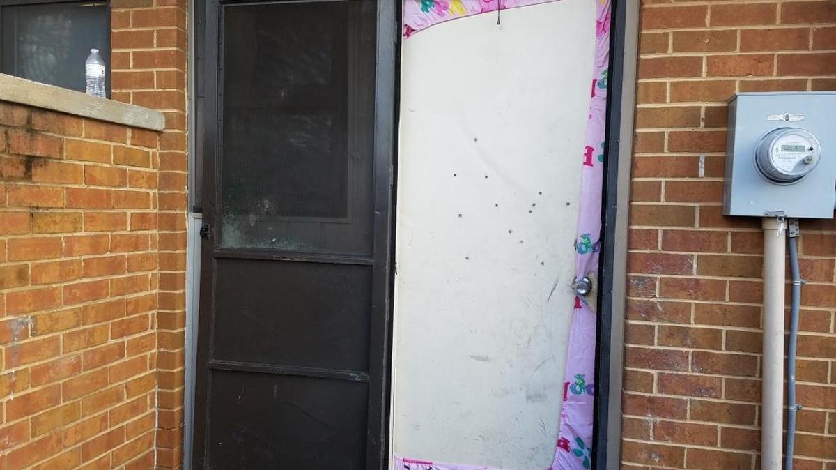 Thirteen bullet holes mark the townhouse where a 22-year-old pregnant woman and a 26-year-old man were shot early Tuesday, January 23, 2018.
