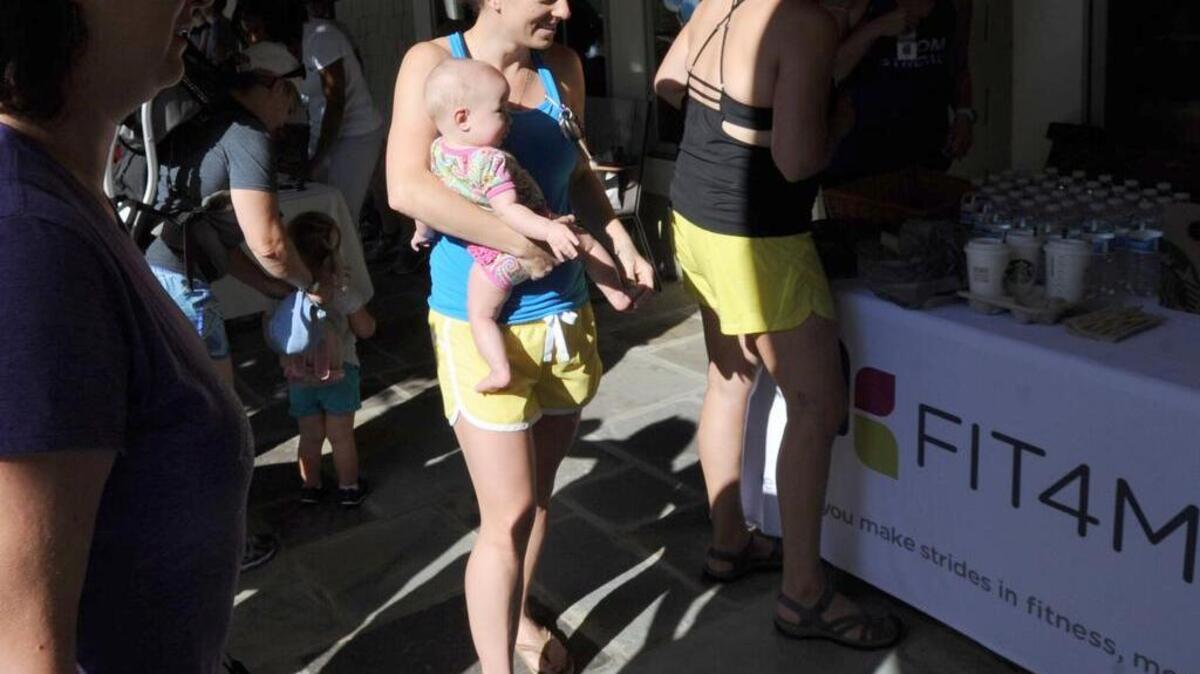 Katie Jones holds her baby, Riley, during the postpartum perinatal mood and anxiety disorders annual "Climb Out of the Darkness 2017” Saturday at the Briar Chapel trail and clubhouse