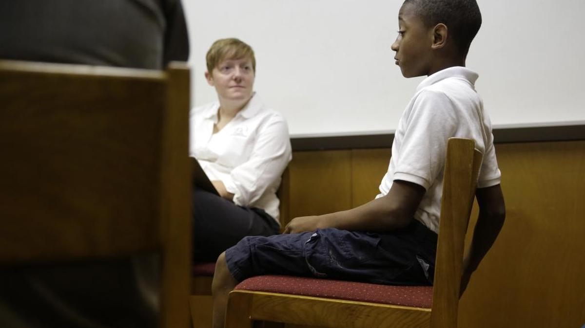 Assistant principal Sarah Tompkins, left, listens as a seventh grader discusses a recent conflict with another student solved through restorative justice, which included teachers and students gathering in circles for discussions, at Ed White Middle School in San Antonio. Three years after starting a restorative discipline program, out-of-school suspensions have dropped by 72 percent. Chapel Hill-Carrbboro schools are now adopting the approach.