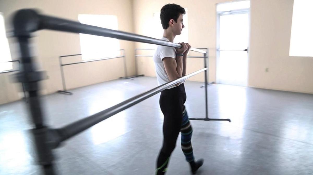 Clark Eselgroth moves a barre in the studio at the International Ballet Academy in Cary where his advanced dance program meets. Eselgroth, a sophomore, moved from Asheville to Cary three years ago and was soon confronted with the question of how to balance school with the hours of daily work required to realize his goal of becoming a professional dancer.