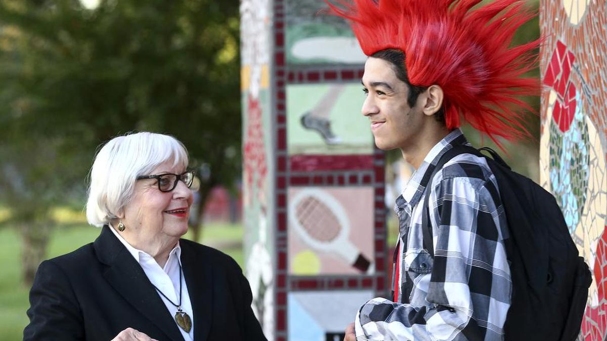 Dr. Bertie Simmons, the 82-year-old principal of Furr High School, jokes around with Joshua Rios, a sophomore, before classes begin Friday, Sept. 30, 2016, in Houston. The attorney for a suspended principal in Houston says his client didn’t disobey a district decision to relax the student dress code after Hurricane Harvey and never threatened a student. Houston Independent School District officials have placed Simmons on leave without pay Sept. 29 because of a personnel matter. The Houston Chronicle reports that Simmons’ attorney Scott Newar wrote a letter to Superintendent Richard Carranza denying the district’s allegations.