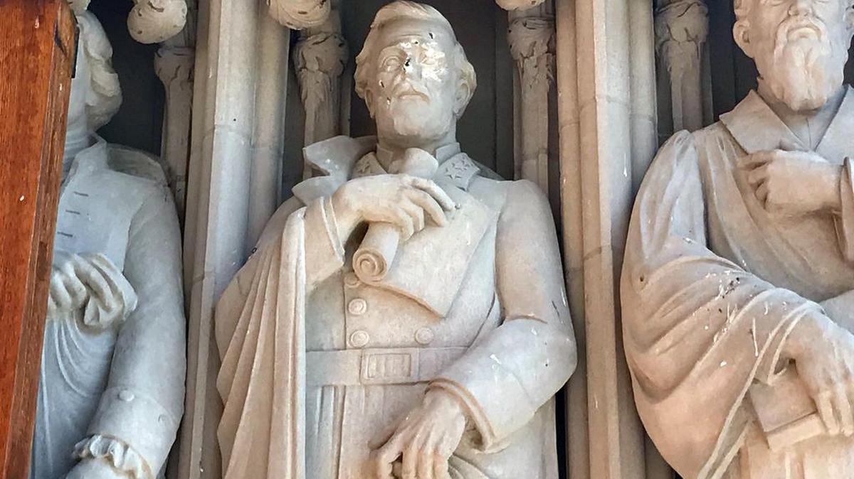 Vandals struck the statue of Confederate Gen. Robert E. Lee, center, outside Duke Chapel on Duke University’s West Campus in mid-August 2017. The statue was later removed.