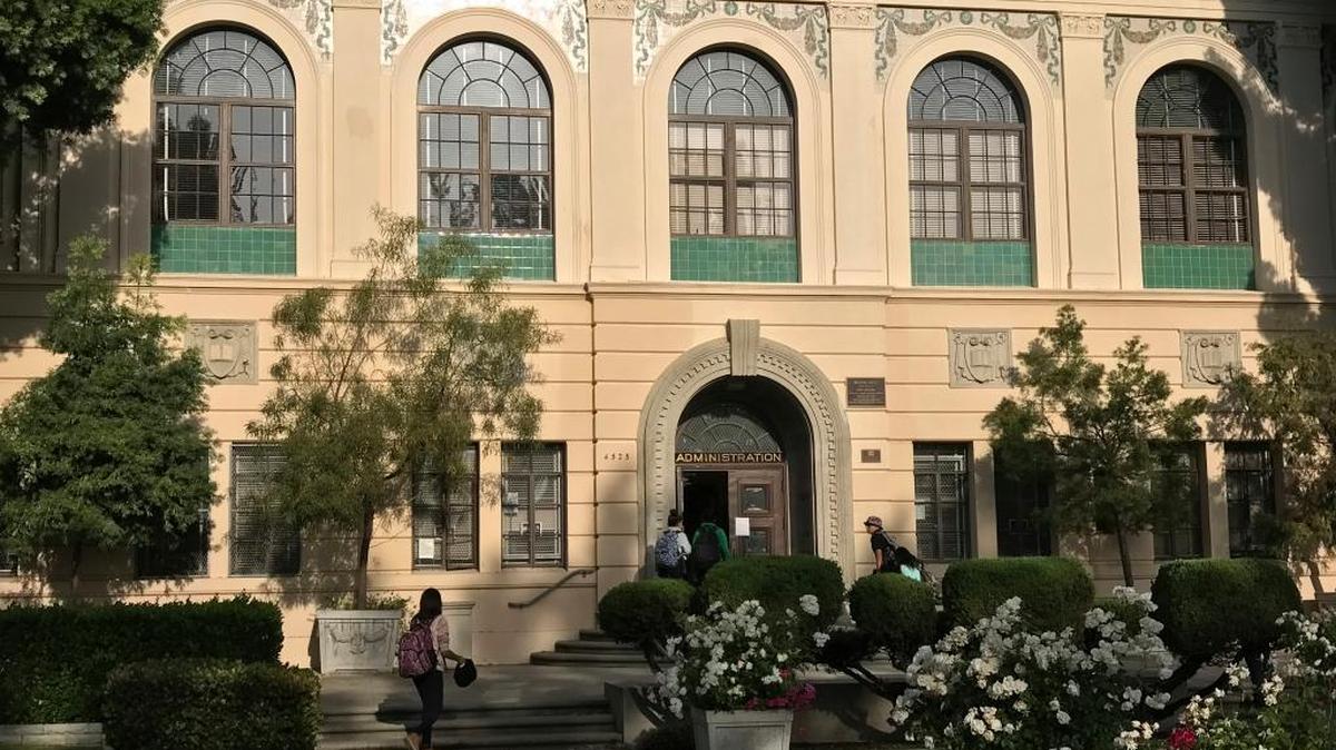 In this Wednesday, May 3, 2017 photo, students arrive at Walter Reed Middle School in Los Angeles. Parents were shocked earlier this year when they learned the school would no longer qualify for the additional staffing due to an uptick in its white student enrollment.