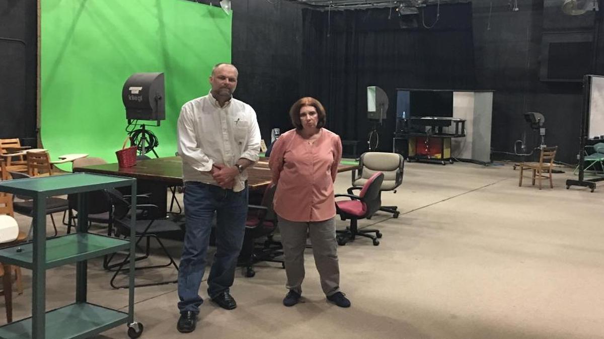 UNC-Chapel Hill professors Mark Robinson and Cori Dauber stand in an empty studio in Swain Hall. They had hoped to use a federal grant to fill the space with students developing multimedia to fight extremist groups.