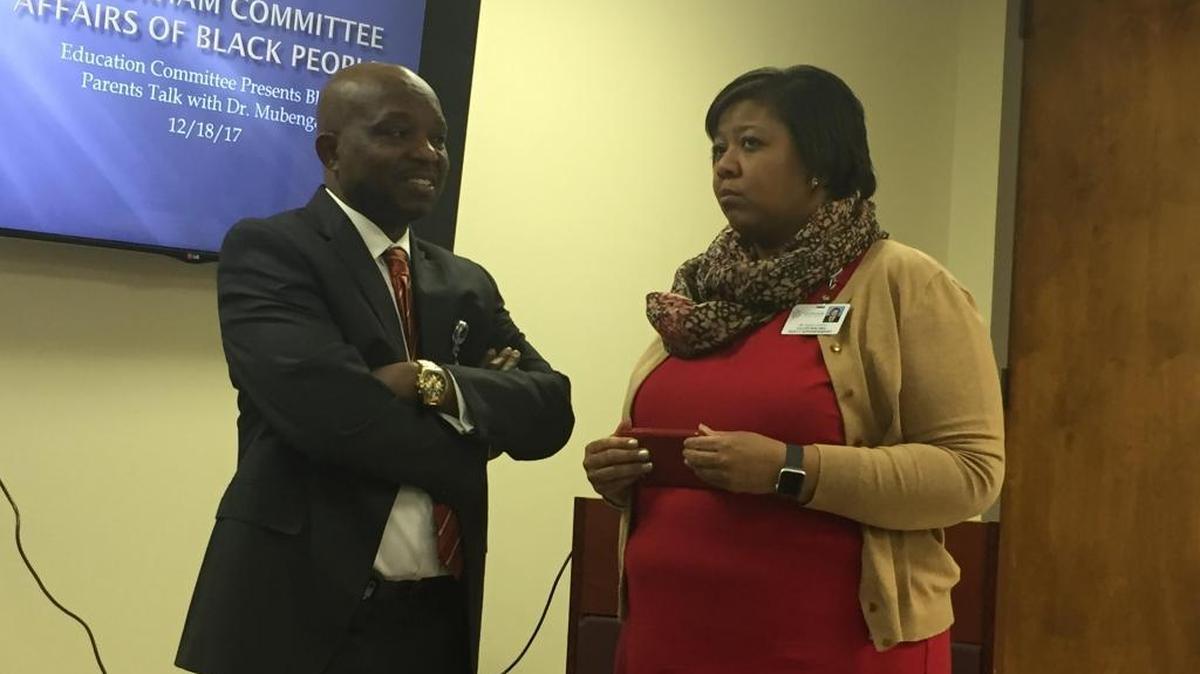 Superintendent Pascal Mubenga chats with Nakia Hardy, the district’s new deputy superintendent of academic affairs, before a meeting with black parents Monday, Dec. 18, as part of a event held by the Education Committee of the Durham Committee on the Affairs of Black People.