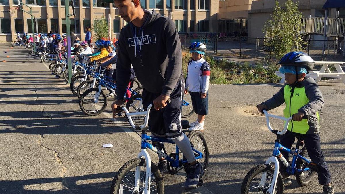 Second-graders learn to ride bikes on the school yard from physical education teacher Terrance Chavis at Seaton Elementary School in Washington. At a time when elementary and high schools are all about getting students ready for college or jobs, physical education teachers are being urged to look beyond graduation, too, to make lifelong movers out of even the least competitive kids.