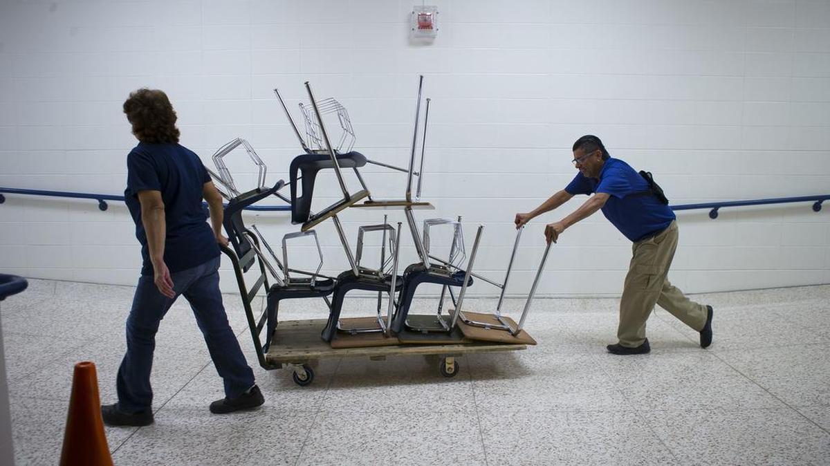 This photo taken Dec. 20, 2017, shows desks being brought back into the high school as staff prepare to move back in to C.E. King High School for the new semester starting in January after having to vacate the school due to damage from Hurricane Harvey, in Houston.