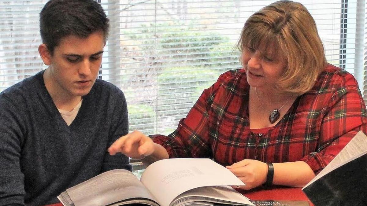 Deborah Brown, the state Charter School Teacher of the Year, works with one of her students at Research Triangle High School.