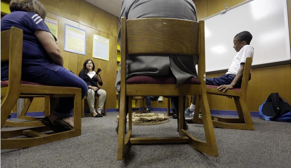 Students in Texas discuss a recent conflict they resolved through restorative justice, which included teachers and students gathering in circles for discussions.