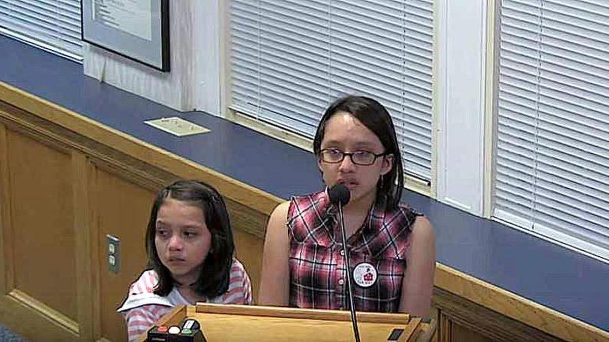 Sisters Abigail Blandin, 9, and Sabrina Blandin, 14, make an emotional plea to the Durham Public Schools Board of Education Thursday night to save teaching positions at Durham School of the Arts.