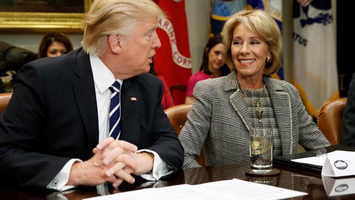 In this Feb. 14, 2017 file photo, President Donald Trump talks to Education Secretary Betsy DeVos in the Roosevelt Room of the White House in Washington.