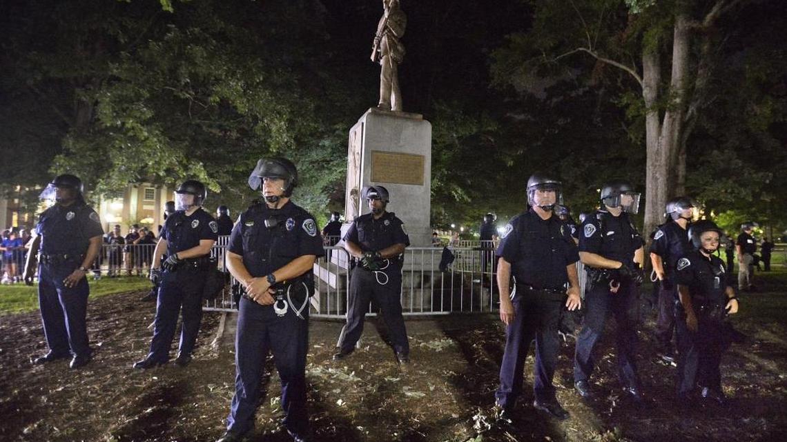 UNC-Chapel Hill police and Orange County sheriff's deputies protect "Silent Sam" on the campus of UNC-Chapel Hill in Chapel Hill, N.C. Tuesday, August 22, 2017. About 400 protesters surrounded the controversial statue for several hours as the students shouted “Tear it down!”