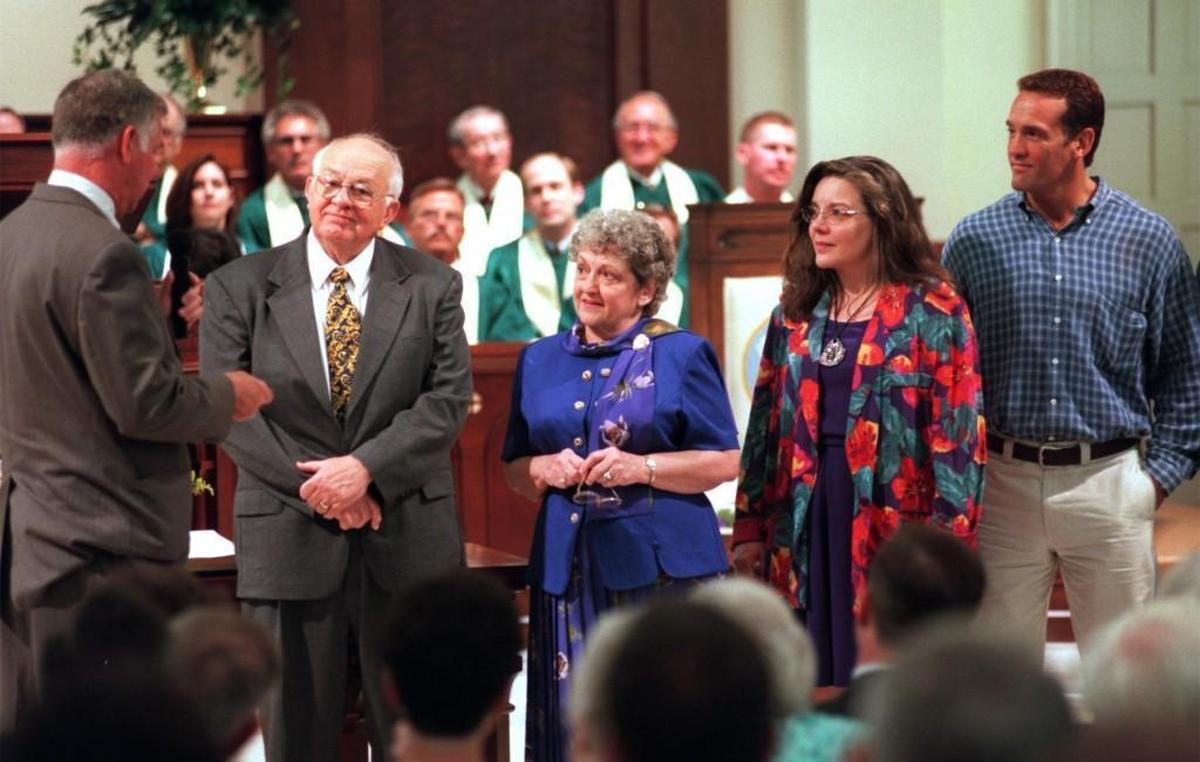 Wake Forest Mayor George Mackie, left, presents an antique house key to the Shipp family, from left, J. Wesley, Shirley, Karen and John Wesley during a church service at Wake Forest Baptist Church in 1999.