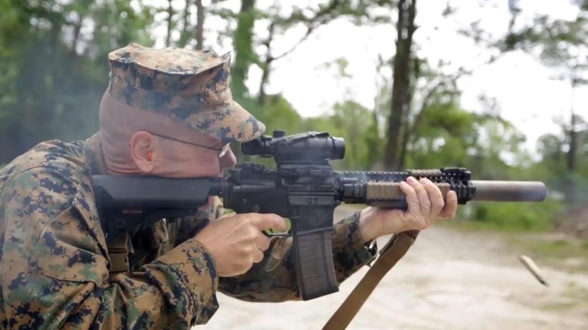 Christian Wade of the 2nd Marine Division at Camp Lejeune shoots a suppressed carbine. The surpressor is the canister on the end of the barrel.