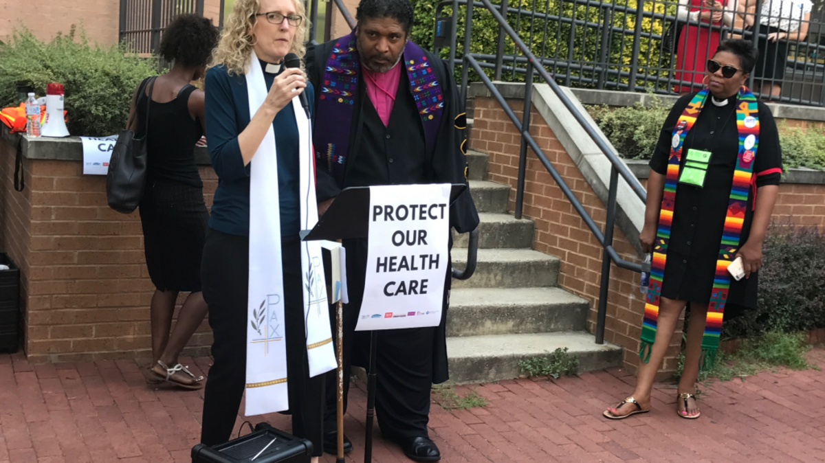 Jennifer Butler, the CEO of Faith in Public Life, and Rev. William Barber, the president of the NC NAACP, gather protesters near the Capitol in Washington, D.C. The pair led a protest of the Senate’s proposed health care legislation in the hallway in front of Senate Majority Leader Mitch McConnell’s office on Thursday, July 13, 2017. Butler and Barber were among 11 protesters arrested.