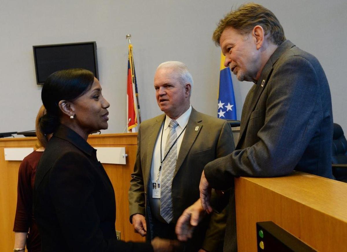 Durham City Council member Don Moffitt, right, spoke with then new Durham Police Chief C.J. Davis, left, in May 2016. At center is City Manager Tom Bonfield.