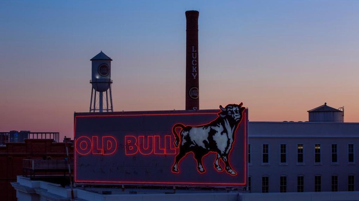 The sun sets behind iconic symbols of downtown Durham on Sunday, July 28, 2017, in Durham, North Carolina. Casey Toth | The Herald-Sun