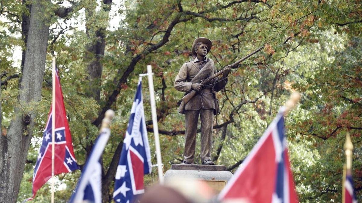 Confederate flags frame the confederate soldier monument known as "Silent Sam" during a rally on UNC campus in Chapel Hill. The rally, held in support of keeping the monument on campus, was held by Alamance County Taking Back Alamance County.