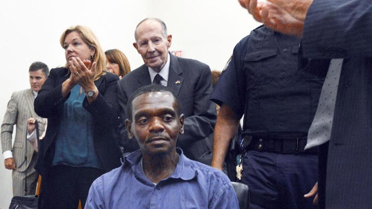 Henry McCollum sits stunned as applause rings out in a Robeson County courtroom in Lumberton, N.C. Tuesday, September 2, 2014 after a judge has declared McCollum and his brother Leon Brown innocent of a brutal rape murder for which they have spent 30 years in prison. The brothers were convicted of the 1983 rape and murder of an 11-year-old girl whose body was found in a soybean field near the tiny town of Red Springs. Behind him is I. Beverly Lake, Jr. founder of the Innocence Commission who were vital in the process to free the two men.