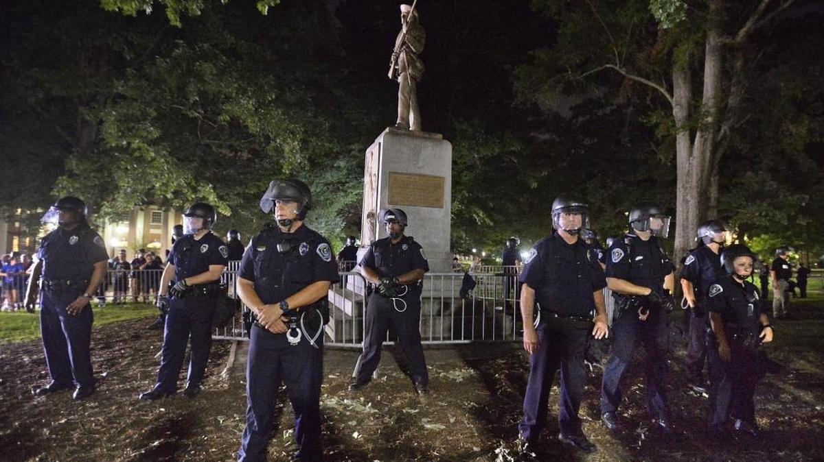 UNC-Chapel Hill police and Orange County Sheriff’s deputies protect “Silent Sam” at UNC- Chapel Hill on August 22, 2017 during a large protest.