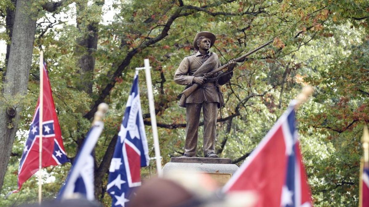 Confederate flags frame the Confederate soldier monument known as “Silent Sam” during a rally on UNC campus in Chapel Hill, N.C. on Sunday, October 25, 2015. The rally, held in support of keeping the monument on campus, was held by Alamance County Taking Back Alamance County.