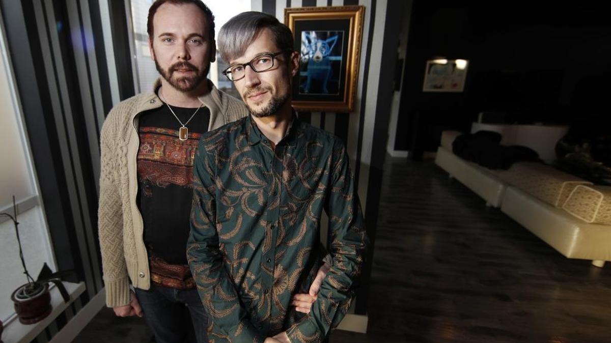 In this Tuesday, Nov. 28, 2017, photograph, Charlie Craig and David Mullins are shown in their home in Denver. The Colorado couple is at the core of a legal case that goes before the U.S. Supreme Court for oral arguments on Tuesday, Dec. 5 in which Denver-area baker, Jack Phillips, cited his Christian faith in refusing to make a cake for the gay couple's wedding celebration in 2012.