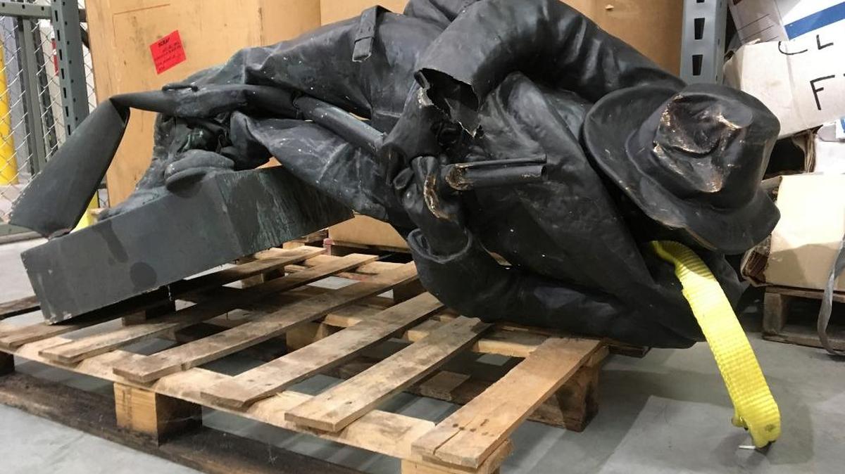 A damaged nearly century-old Confederate statue lies on a pallet in a warehouse in Durham, N.C. on Tuesday, Aug. 15, 2017. The Confederate Soldiers Monument, dedicated in 1924, stood in front of an old courthouse building that serves as local government offices.