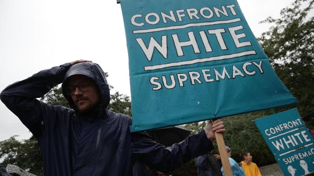 Members of The March to Confront White Supremacy gather for a brief rally behind the Martin Luther King Jr. Memorial on Sept. 6, 2017 in Washington, DC. Marchers completed a 118-mile long journey from Charlottesville to Washington, DC, calling for the dismantling of white supremacy.