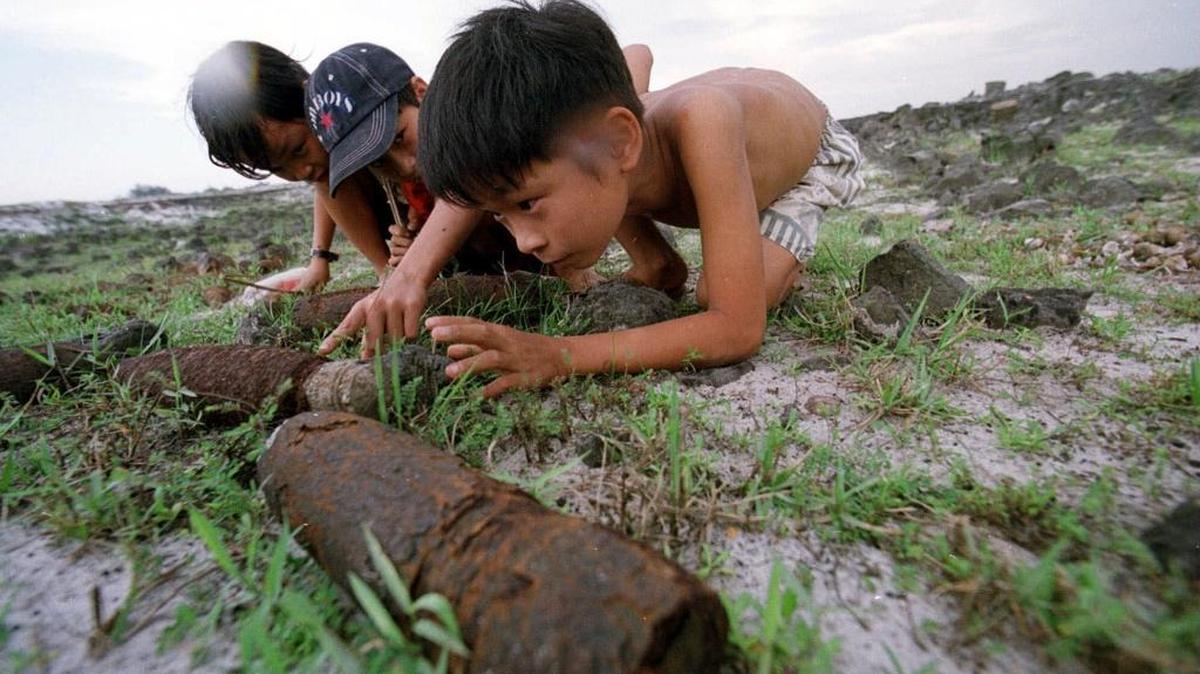 Vietnamese children inspect rusted artillery shells in a field at a former U.S. military base in Dong Ha in central Vietnam in this 2000 photo. Since 1975, over 40,000 Vietnamese have died from these deadly remnants of war, and over 60,000 innocent victims have been injured.