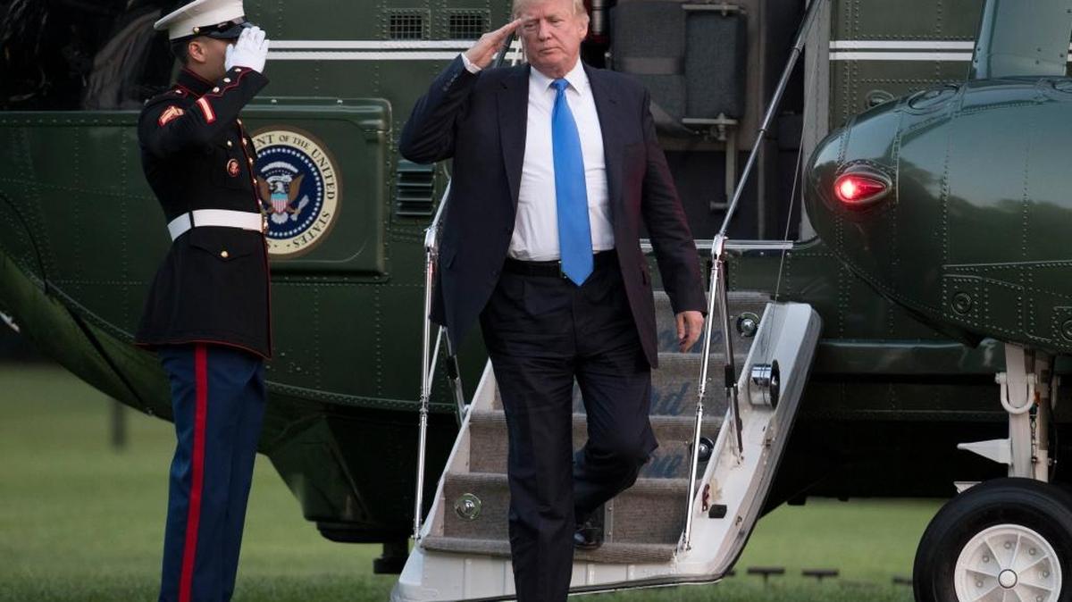 President Donald Trump salutes as he steps from Marine One on the South Lawn of the White House in Washington, Sunday, June 11, 2017, as he returned from Bedminster, N.J.