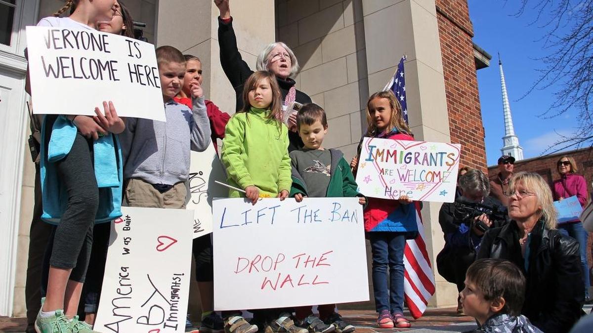 A group rallies against President Donald Trump’s immigration policies Jan. 29, 2017, on Peace and Justice Plaza outside the Franklin Street post office in Chapel Hill.