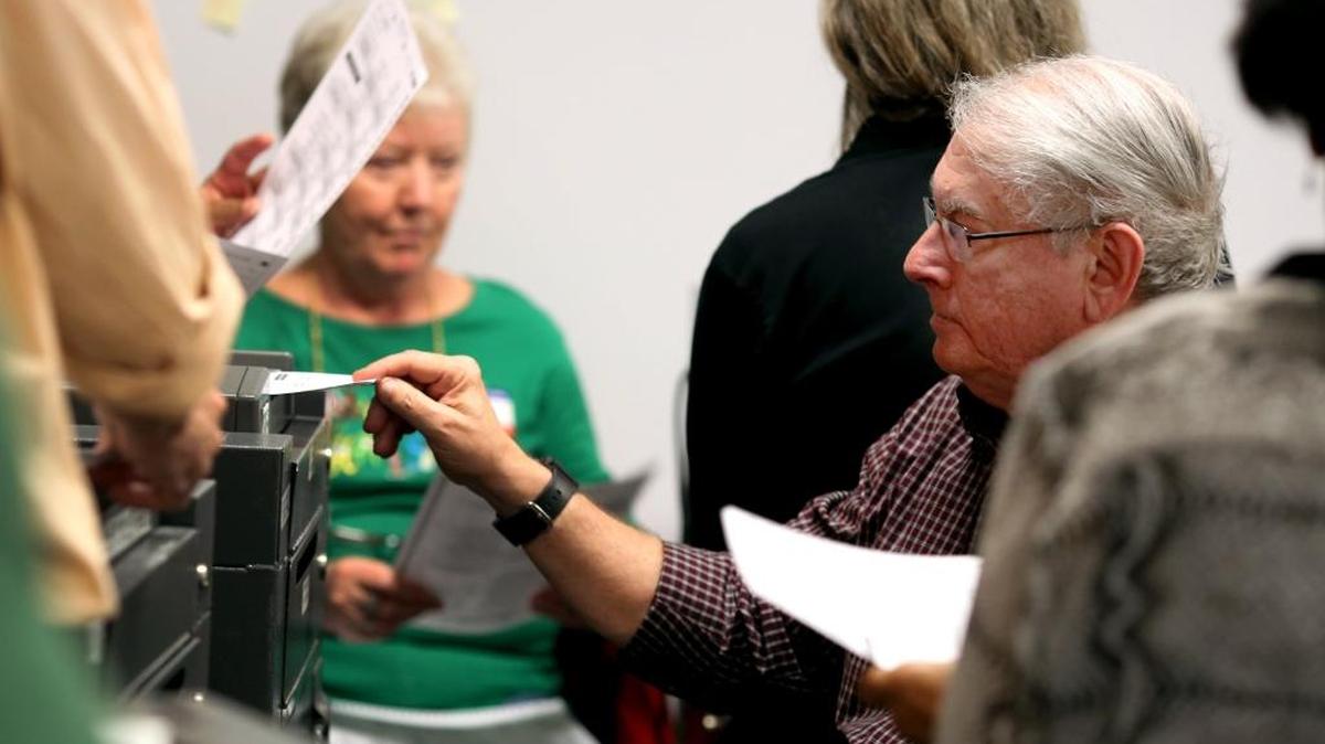 Paid volunteers process ballots during the second day of a Durham County vote recount at the Durham County Board of Elections on Sunday, Dec. 4, 2016.
