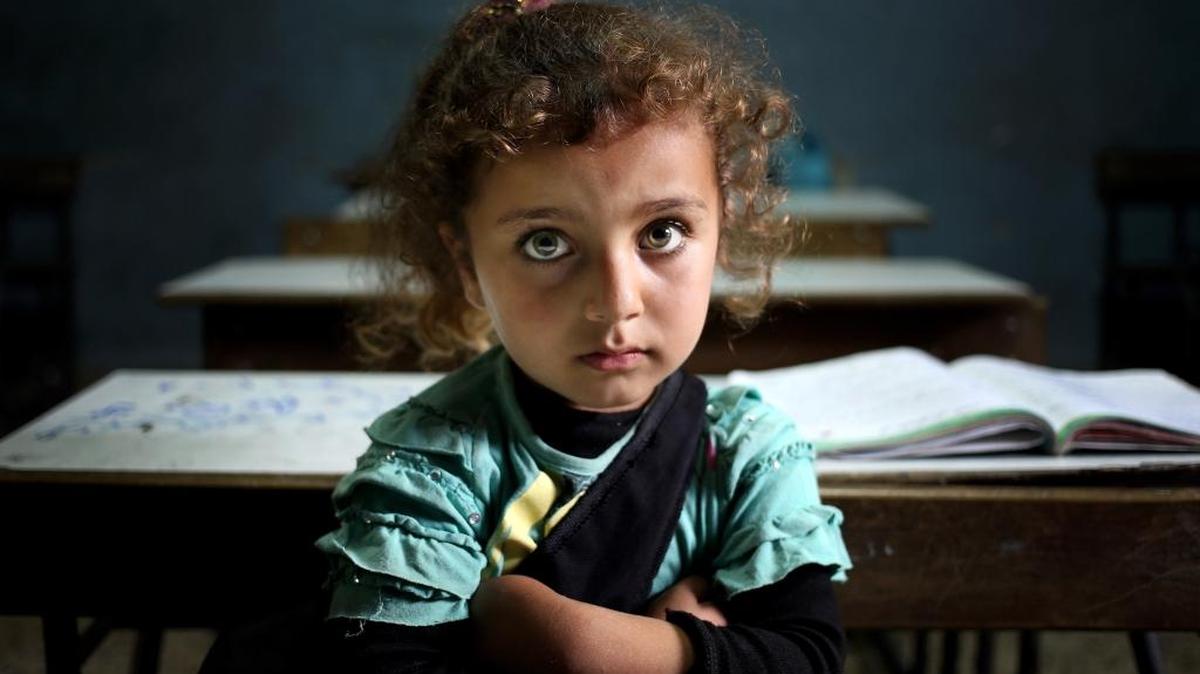 In this 2014 file photo, a Syrian refugee girl sits in a classroom at a Lebanese public school where only Syrian students attend classes in the afternoon, at Kaitaa village in north Lebanon. UNICEF said in 2016 that one-third of Syrians under the age of 18, or about 3.7 million, were born since an uprising against President Bashar Assad erupted in 2011 and escalated into a civil war.