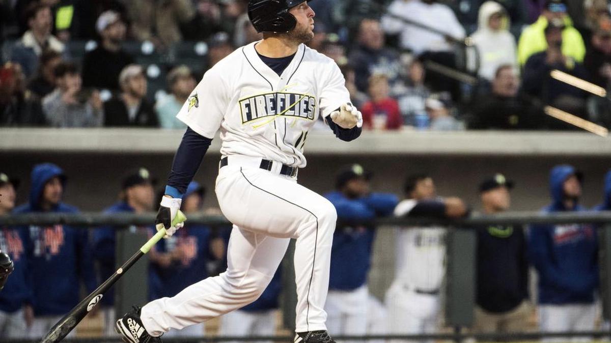 In this April 6, 2017, file photo, Columbia Fireflies’ Tim Tebow watches his home run in his first at-bat on the opening day during a Class A minor league baseball game against the Augusta GreenJackets in Columbia, S.C. Tebow said Friday, Nov. 24, 2017, that he spends three-to-five days a week training for baseball, getting himself ready for Year 2 of his pro baseball career in the New York Mets organization.