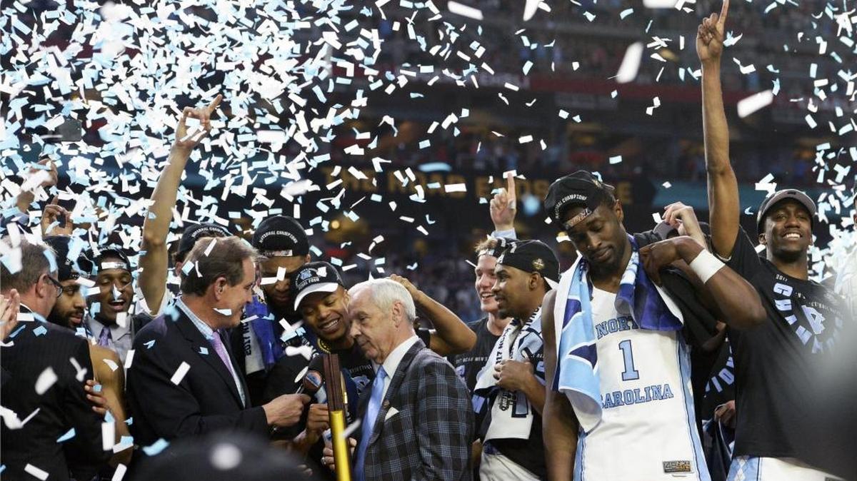 UNC coach Roy Williams and his team are peppered with confetti after beating Gonzaga 71-65 in the NCAA tournament championship game on April 3, 2017 in Glendale, Ariz.