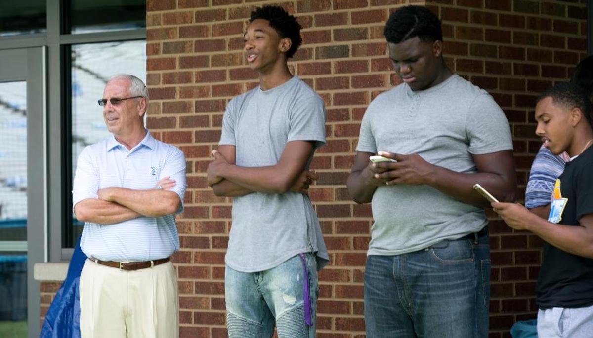 North Carolina coach Roy Williams watches the football team warm up for their game against James Madison with recruit Rechon Black, to his left, in September.