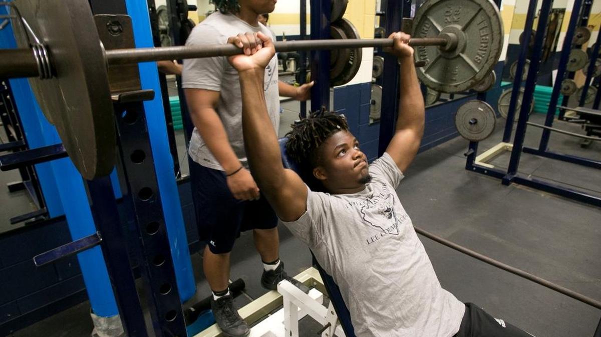 Jahmir Smith lifts weights during his first period class at Lee Senior High School in May.