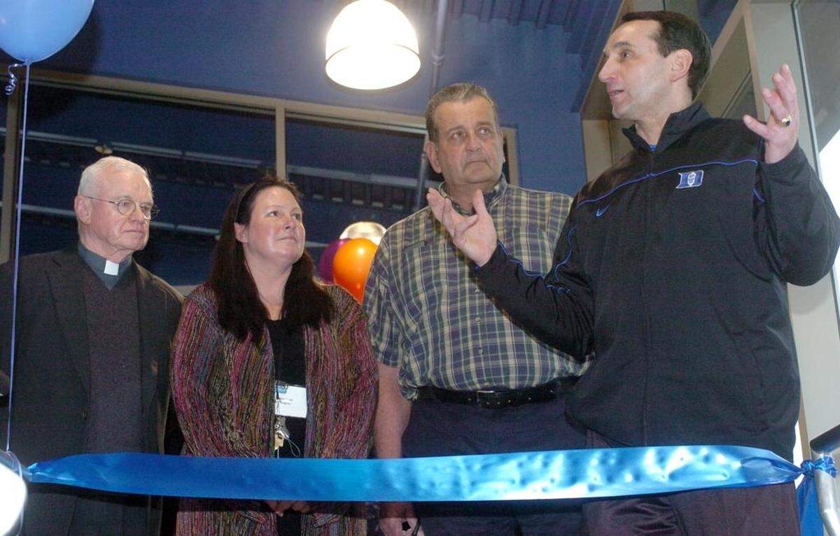 Father David McBriar, Marleah Rogers with the Emily Krzyzewski Center, and Bill Krzyzewski listen as Duke coach Mike Krzyzewski addresses the crowd before the ribbon cutting at the new Emily Krzyzewski Center in 2006.