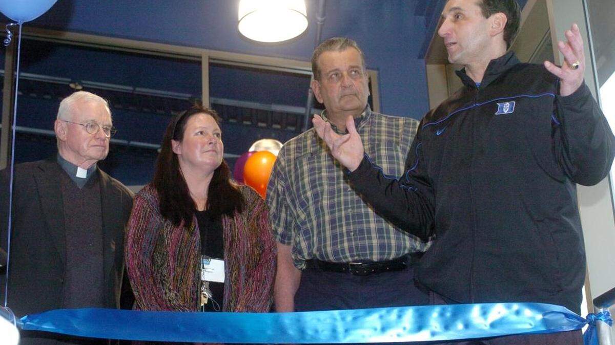 Father David McBriar, Marleah Rogers with the Emily Krzyzewski Center, and Bill Krzyzewski listen as Duke coach Mike Krzyzewski addresses the crowd before the ribbon cutting at the new Emily Krzyzewski Center in 2006.
