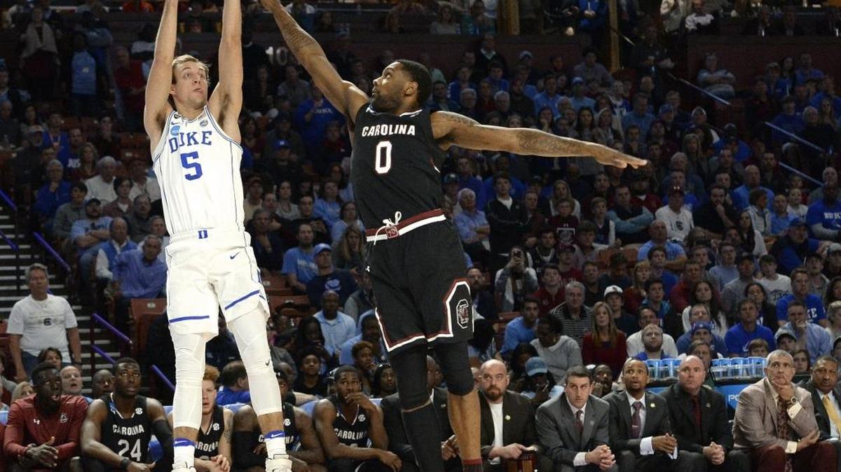 Duke guard Luke Kennard (5) fires up a first half three pointer as South Carolina guard Sindarius Thornwell (0) defends. South Carolina upset the Blue Devils 88-81at the Second Round of the NCAA tournament Sunday, March 19, 2017, at the Bon Secours Wellness Arena in Greenville, S.C.