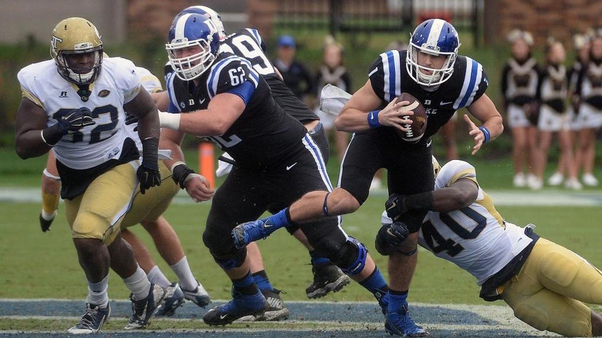 Duke quarterback Thomas Sirk (1) gets a block from center Matt Skura (62) and looks for a first down as Georgia Tech linebacker P.J. Davis (40) tries to pull him down during a Sept. 26, 2015 at Wallace Wade Stadium in Durham.