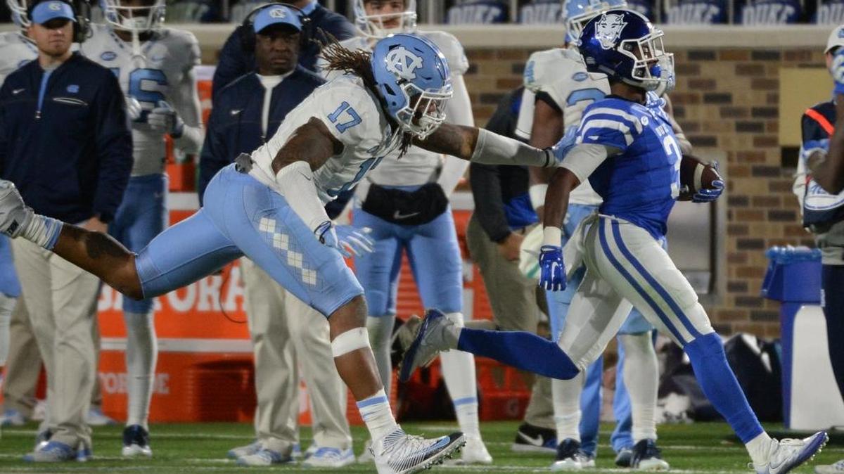 Duke wide receiver T.J. Rahming, right, is shoved out of bounds by North Carolina defensive end Dajaun Drennon in Duke’s 28-27 win over the Tar Heels in November.