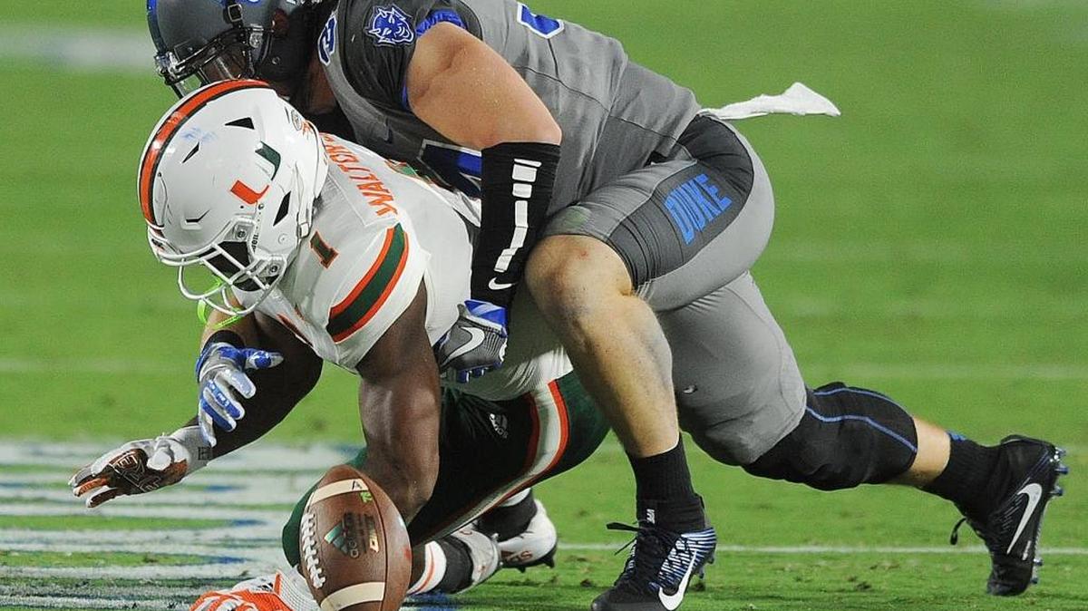 Duke's Ben Humphreys takes down Miami's Mark Walton (1), Friday, September 29, 2017, in Wallace Wade Stadium.