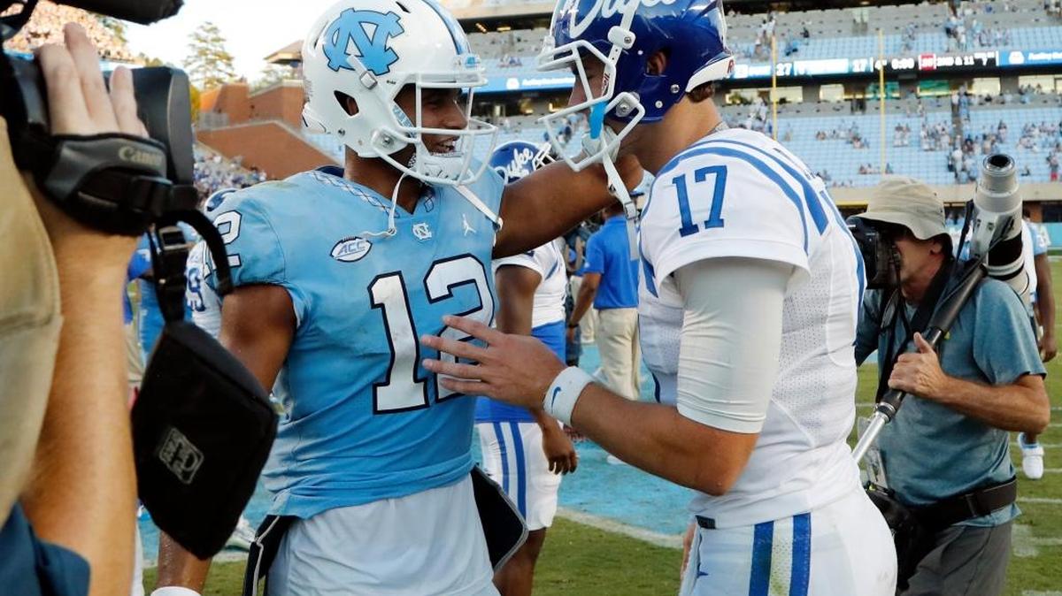 UNC quarterback Chazz Surratt, left, and Duke quarterback Daniel Jones, right, meet at the end of Duke’s 27-17 win over UNC on Saturday.